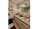 Bathroom features dual pink sinks, granite countertops, and vintage decor at 359 Cornish Mtn Rd, Oxford, GA 30054