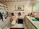 Bathroom with white fixtures, snowman themed decor, and pink tile at 359 Cornish Mtn Rd, Oxford, GA 30054