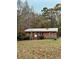 Cozy single-story brick home with a metal roof and ladder propped on side for future updates at 359 Cornish Mtn Rd, Oxford, GA 30054