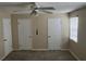 Spacious bedroom featuring a ceiling fan, neutral walls, and two convenient closets at 2705 Greystone Pl, Austell, GA 30106