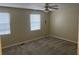 Empty bedroom with tan carpet, tan walls, and two windows for ample natural light at 2705 Greystone Pl, Austell, GA 30106
