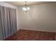 A simple dining room with tiled floor, curtains and an elegant chandelier at 2705 Greystone Pl, Austell, GA 30106