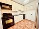 Cozy kitchen featuring a stove, microwave, and ample white cabinetry for storage at 2705 Greystone Pl, Austell, GA 30106