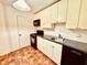 Compact kitchen featuring a stove, microwave, and abundant white cabinetry for storage at 2705 Greystone Pl, Austell, GA 30106
