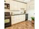 Well-lit kitchen featuring modern black appliances, light countertops, and sleek cabinets at 2705 Greystone Pl, Austell, GA 30106