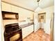 Functional kitchen featuring ample white cabinetry, a sink, and black appliances at 2705 Greystone Pl, Austell, GA 30106