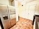 Well-lit kitchen featuring a modern stainless steel refrigerator and tile floors at 2705 Greystone Pl, Austell, GA 30106