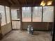 Enclosed porch featuring screens, a concrete floor, a painted interior, and a view of the fenced back yard at 2705 Greystone Pl, Austell, GA 30106