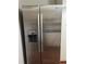Stainless steel Whirlpool side-by-side refrigerator with water and ice dispenser at 2705 Greystone Pl, Austell, GA 30106