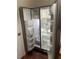 Interior view of a stainless steel side-by-side refrigerator showing shelves at 2705 Greystone Pl, Austell, GA 30106
