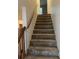 A carpeted staircase with a wooden railing leads to the upper floor at 2705 Greystone Pl, Austell, GA 30106