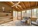 A beautifully staged sunroom with comfortable seating, wood paneled walls, and lots of natural light at 2705 Greystone Pl, Austell, GA 30106