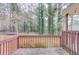Cozy wooden back deck overlooking a wooded area, perfect for outdoor relaxation and enjoying the natural surroundings at 370 Charlyne Way, Dacula, GA 30019