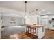 Open kitchen and living room with a breakfast bar and modern lighting at 370 Charlyne Way, Dacula, GA 30019