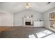 Bright living room with a charming fireplace, neutral paint and plush carpeting at 370 Charlyne Way, Dacula, GA 30019