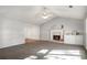 Bright living room with a charming fireplace, neutral paint and plush carpeting at 370 Charlyne Way, Dacula, GA 30019