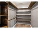 Spacious walk-in closet with custom wooden shelving providing ample storage and organization space at 370 Charlyne Way, Dacula, GA 30019