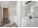 Well-lit bathroom featuring a white vanity and a glimpse into an adjacent walk-in closet at 2612 Grove Park Ln, Conyers, GA 30094