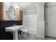 Traditional bathroom with a pedestal sink, tub shower, and wainscoting at 2612 Grove Park Ln, Conyers, GA 30094