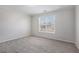 A cozy bedroom with neutral carpet and a window with blinds for privacy at 2612 Grove Park Ln, Conyers, GA 30094