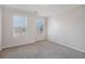 Neutral bedroom with carpet, two windows bringing in natural light, and baseboard trim at 2612 Grove Park Ln, Conyers, GA 30094