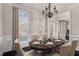 Formal dining room featuring hardwood floors, elegant chandelier, and seamless flow to the living spaces at 2612 Grove Park Ln, Conyers, GA 30094