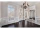 Formal dining room featuring hardwood floors, bright windows, and seamless flow to the living spaces at 2612 Grove Park Ln, Conyers, GA 30094