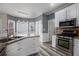Well-lit kitchen featuring white cabinets, stainless steel appliances, and a stylish island at 2612 Grove Park Ln, Conyers, GA 30094