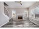 Bright and airy living room featuring luxury vinyl plank flooring and a classic fireplace and staircase at 2612 Grove Park Ln, Conyers, GA 30094