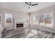 Comfortable living room features fireplace, luxury vinyl plank flooring, and natural light from bright windows at 2612 Grove Park Ln, Conyers, GA 30094