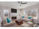Bright living room features a fireplace, large windows, and comfortable seating with blue accent pillows at 2612 Grove Park Ln, Conyers, GA 30094