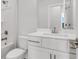 This bathroom with tub features a single sink vanity with white cabinets and chrome hardware at 822 Urban Grange Way, Suwanee, GA 30024
