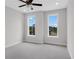 Bright bedroom with plush carpet, a ceiling fan, and large windows overlooking the community at 822 Urban Grange Way, Suwanee, GA 30024