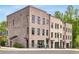 Contemporary brick townhomes featuring modern design elements and professional landscaping at 822 Urban Grange Way, Suwanee, GA 30024