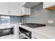 Modern kitchen featuring stainless steel appliances, white cabinets, and sleek countertops at 822 Urban Grange Way, Suwanee, GA 30024