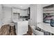 Modern eat-in kitchen with white cabinets, stainless steel appliances, and hardwood flooring at 822 Urban Grange Way, Suwanee, GA 30024