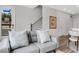 Cozy living room with a comfortable sofa, artwork, and a view of the community entrance at 822 Urban Grange Way, Suwanee, GA 30024