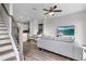 Bright open-concept living room with modern furniture, hardwood floors, and staircase to the left at 822 Urban Grange Way, Suwanee, GA 30024