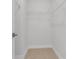 A walk-in closet with white wire shelving and neutral carpet shows ample storage space at 822 Urban Grange Way, Suwanee, GA 30024