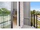 Private balcony featuring railings, brick siding, and a sliding glass door to the living area at 913 Echo Park Dr, Suwanee, GA 30024