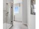 Bathroom showcasing a marble shower and window for natural light at 913 Echo Park Dr, Suwanee, GA 30024