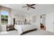 Comfortable bedroom with decorative headboard, plush carpet, and large windows at 913 Echo Park Dr, Suwanee, GA 30024