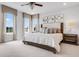 Bright bedroom featuring large windows, plush carpeting, and a decorative headboard at 913 Echo Park Dr, Suwanee, GA 30024