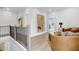 Upstairs landing features contemporary art, a brown couch, and hardwood floors at 913 Echo Park Dr, Suwanee, GA 30024