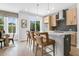 Modern kitchen featuring an island with seating, stainless steel appliances, and wood flooring at 913 Echo Park Dr, Suwanee, GA 30024
