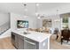 Open concept living area with a kitchen island, dining area, and comfortable living space at 913 Echo Park Dr, Suwanee, GA 30024