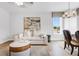 Bright living room with modern furniture, stylish decor, and an open layout that connects to the dining area at 913 Echo Park Dr, Suwanee, GA 30024
