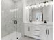 Bright bathroom featuring a glass enclosed shower and double vanity with modern fixtures at 923 Echo Park Dr, Suwanee, GA 30024