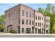 Beautiful townhome with brick exterior, well-placed windows, and professional landscaping, offering curb appeal at 923 Echo Park Dr, Suwanee, GA 30024