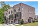 Contemporary townhome exterior with private garages, balconies, and attractive brickwork, ideal for city living at 923 Echo Park Dr, Suwanee, GA 30024